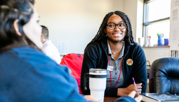 City Year AmeriCorps member with students in school