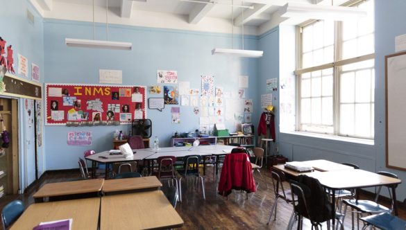 A classroom with desks in small groups.