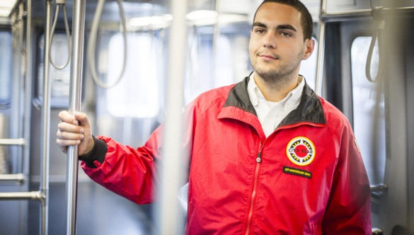 An AmeriCorps member rides the subway.