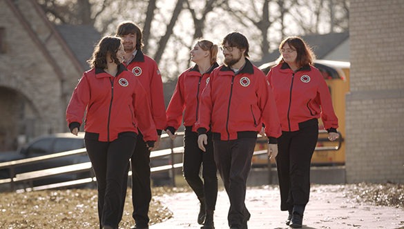 Five City Year AmeriCorp members chatting as they walk outside