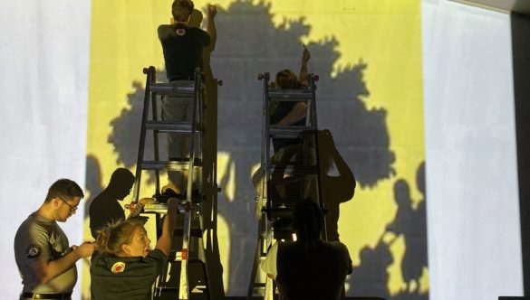 Team Care Force and Reserves sketch a mural at night