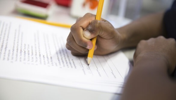 City Year student learning pencil and paper